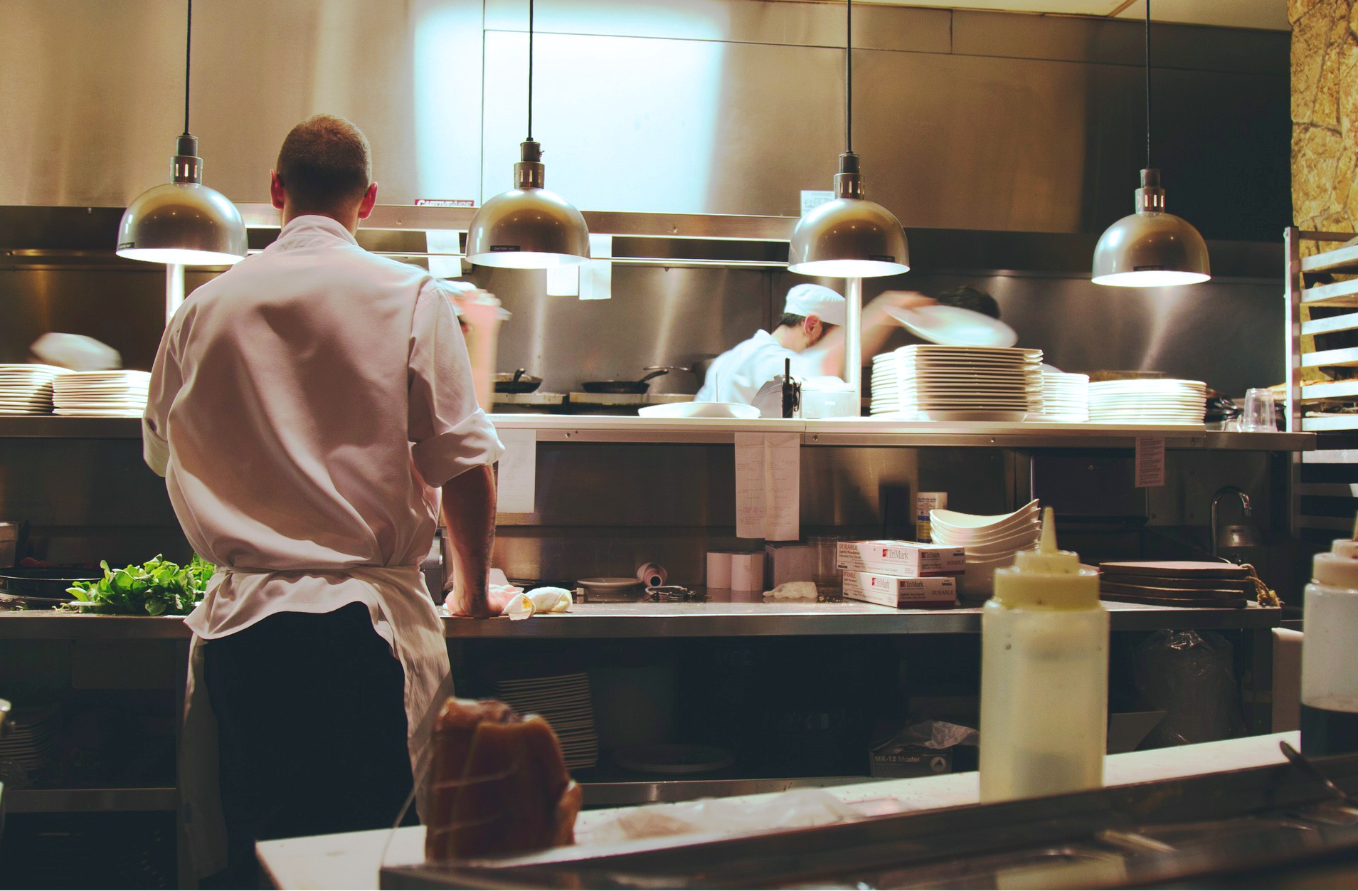 Wäscheservice Waschen Arbeitskleidung Personen arbeiten in einer Großüche